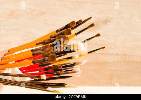 Paint brushes set, close-up. Marketing photo. white background, Studio shot.On the table. Stock Photo