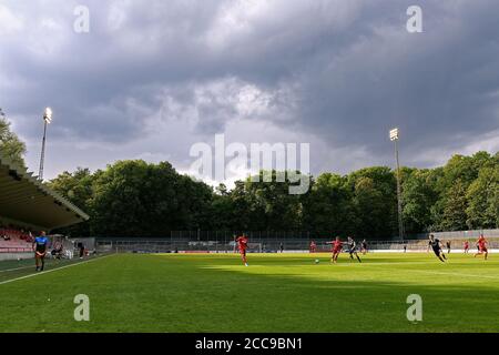 Soccer match in the Franz Kremer Stadium under a dramatic sky. Stock Photo