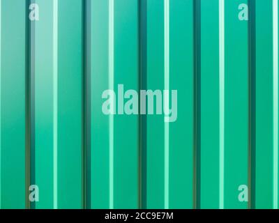 Stainless green colored galvanized profiled sheet. Background or texture concept. Top view. Seamless pattern. Stock Photo
