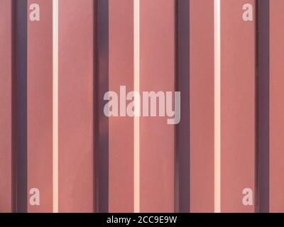 Stainless brown colored galvanized profiled sheet. Background or texture concept. Top view. Seamless pattern. Stock Photo