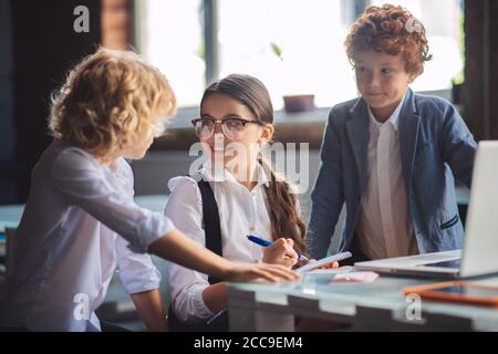 Three cute kids working on lessons together Stock Photo