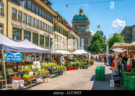 Bern Switzerland , 27 June 2020 : People at farmer market on Barenplatz square and Bundeshaus federal building in background in Bern old town Switzerl Stock Photo