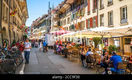 Bern Switzerland , 27 June 2020 : Pedestrian street with cafe terrace full of people during summer 2020 in Bern old town Switzerland Stock Photo