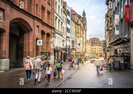 Basel Switzerland , 29 June 2020 : People on Freie Strasse main pedestrian shopping street and old buildings in Basel old town Switzerland Stock Photo