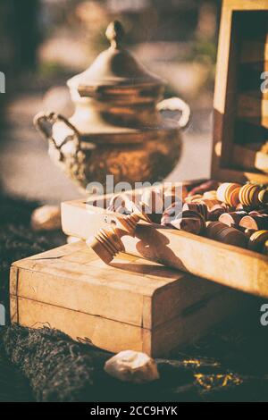 Still life with tea kettle and chess pieces in wooden box, post-processed to have a vintage  look Stock Photo