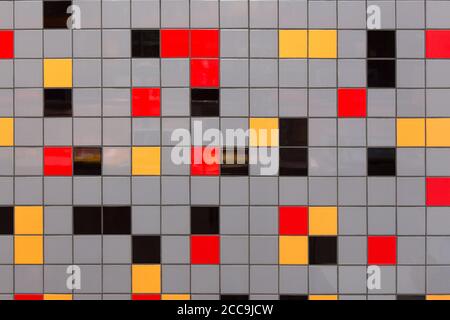 A background with wall that is abstractly lined with multicolored ceramic tiles Stock Photo