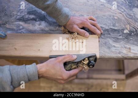 The carpenter is using a jointer. Top view. Stock Photo