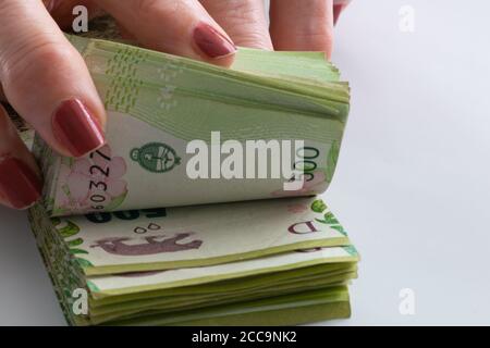 woman´s hands counting Argentine five  peso bills Stock Photo