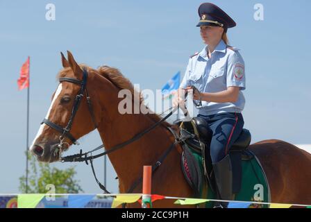 Lytkarino, Moscow region, Russia - July 12, 2014: Julia Lysenko from Moscow police warms up her horse during Russian championship in trick riding. Stock Photo