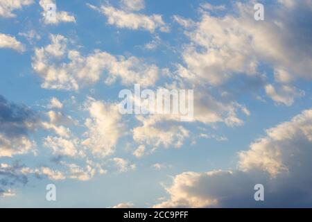 cloudy sky in yellow light. natural background at sunrise. inspiring scene Stock Photo