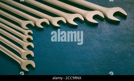 View of set of various work spanner on dark background, stylized, shallow depth of sharpness Stock Photo