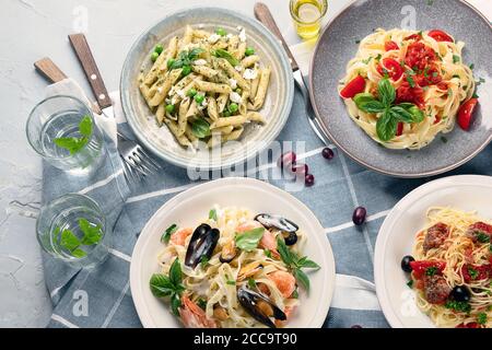 Plates of pastas with different kinds of sauces, top view.  Italian food concept. Stock Photo