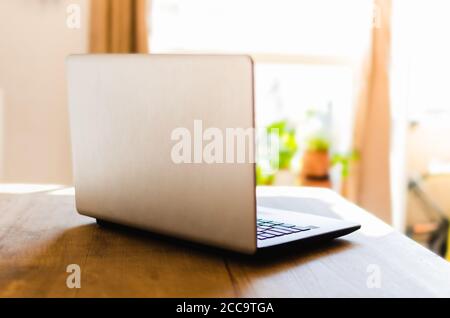 Tabletop Backside Closeup shot of the backside of a laptop on a wooden table Stock Photo ...