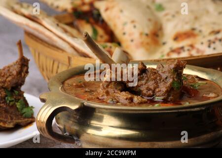 Bhuna Gosht Mutton masala OR Indian Lamb masala and mutton curry Served with naan or bread and onion over moody background. Stock Photo
