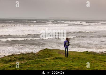 Garrettstown, Cork, Ireland. 20th August, 2020. French visitor Axelle Josselin wathchs the power of the Wild Atlantic Way in the aftermath of Storm Ellen in Garrettstown, Co. Cork, Ireland.  - Credit; David Creedon / Alamy Live News Stock Photo