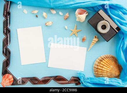 Top view composition - Blank paper photo frames with starfish, shells and items on wooden table. Concept of remembrance and nostalgia in summer touris Stock Photo