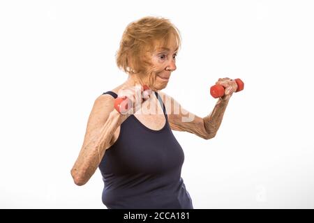 Senior Woman Concentrating On Lifting Two Pound Dumbbells Stock Photo