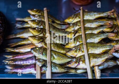 Grilled sardines in an Asian market. Here the fish market is really popular and the food is always fresh and tasty Stock Photo