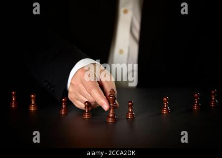Hand of businessman moving chess figure in competition success play. Strategy, management or leadership concept Stock Photo