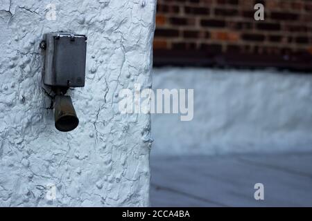 Metal ventilation end of a boiler system, on an urban apartment rooftop, with an exterior brick wall in the background Stock Photo