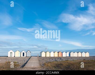 beach huts in cayeux s mer in french normandy under blue sky Stock Photo