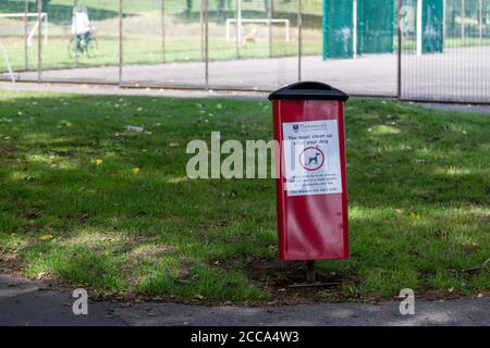 A dog waste bin in the middle of a park Stock Photo