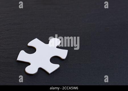 White jigsaw puzzle pieces on gray background Stock Photo