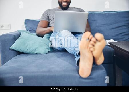 Positive delighted international man working on distance Stock Photo