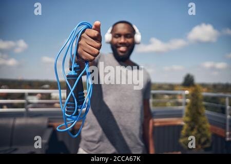Focused photo on male hand that holding skipping-rope Stock Photo