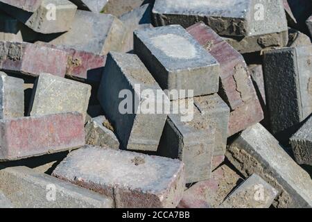 Disassembled building bricks stacked in a large pile close up Stock Photo