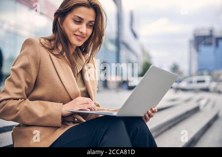 Concentrated woman staring at the laptop screen Stock Photo