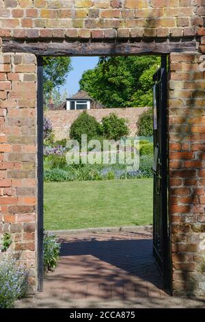 Doorway looking into the 17th-century Walled Garden at Eastcote House, with Grade 11 listed 18th Century Dovecote in the background. Hillingdon, NW Lo Stock Photo