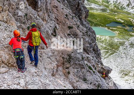 Italy Veneto - Girl on the via ferrata (Innerkofler-De Luca) to Monte Paterno with mountain guide Stock Photo