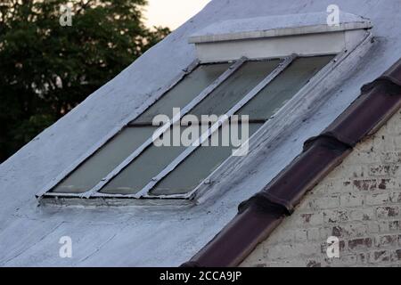 Staircase airshaft exterior window, with painted brick wall Stock Photo