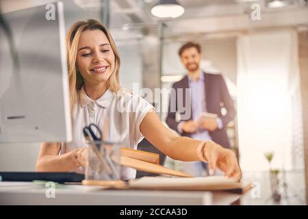 Charming young woman working in modern office Stock Photo