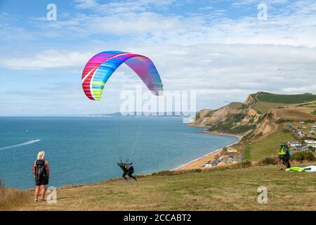 A Paraglider about to take off near Eype mouth beach along the South West Coast Path, on the Jurassic Coast, Dorset, England, UK Stock Photo