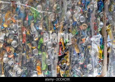 Background of various compressed aluminium cans in plastic wrap. Pollution, business and ecology concept Stock Photo