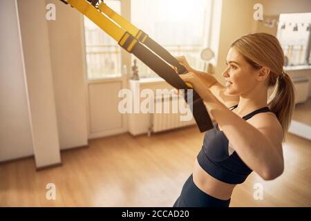 Smiling attractive lady doing a row exercise Stock Photo