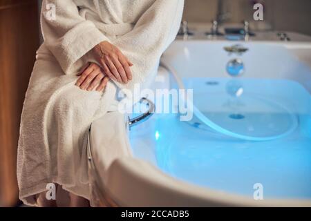Woman in a bathrobe ready for a spa procedure Stock Photo