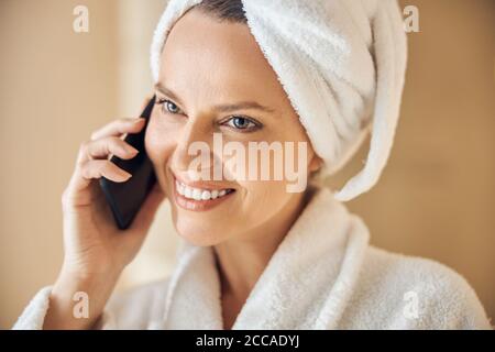 Smiling young Caucasian woman using her gadget Stock Photo