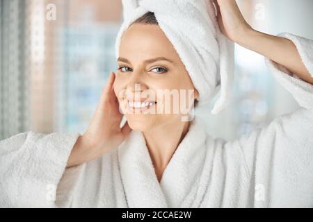 Lady with raised hands smiling at the camera Stock Photo