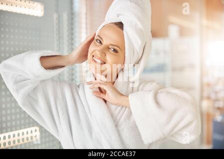 Contented woman touching her face with her hands Stock Photo