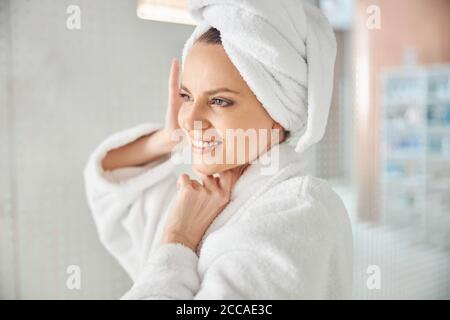 Dreamy pleased spa client gazing into the distance Stock Photo