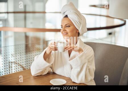 Cheerful pretty lady holding a tea cup Stock Photo