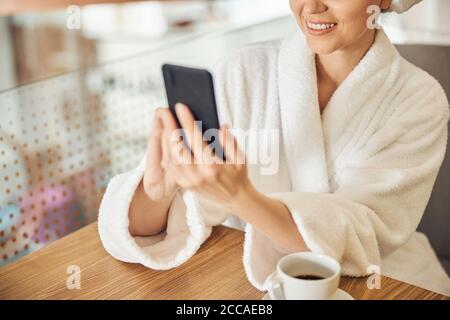 Woman using her gadget at the table Stock Photo
