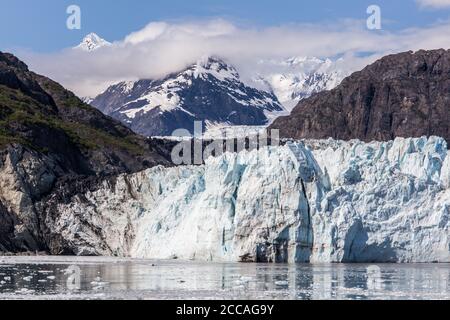 Glacier Bay Alaska cruise vacation travel. Global warming and climate change concept with melting ice. Cruising boat towards landscape of Johns Hopkin Stock Photo