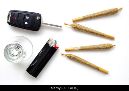 Cannabis Joints Cigarettes with car key, a shoot glass and a lighter on a  leather black texture. Concept driving high. Drug-impaired driving is  danger Stock Photo