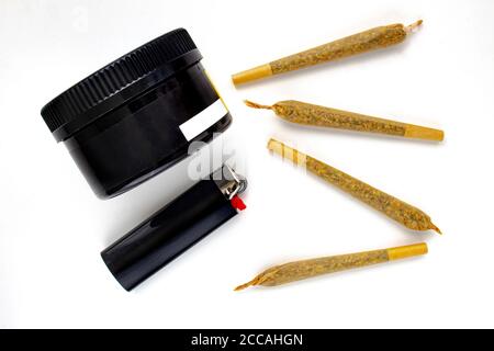 A Cannabis black plastic packaging container with Cigarettes, Prerolls or Joints and a lighter on a white background Stock Photo