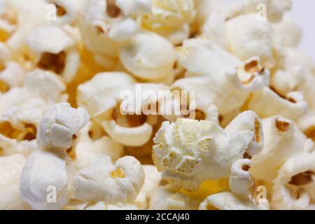 lots of yummy popcorn on white background Stock Photo