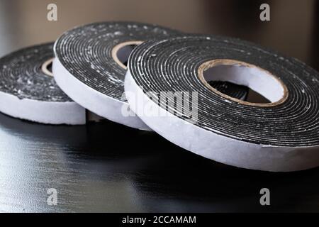 Three reels of double-sided tape on wooden table Stock Photo